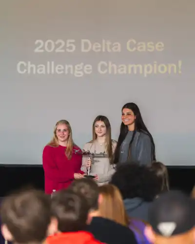 three students receiving award